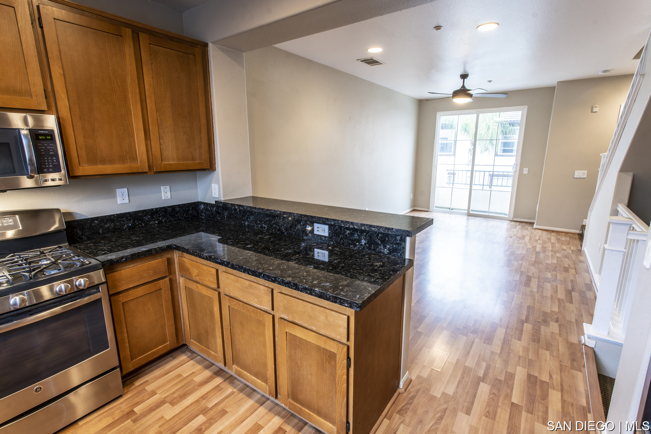 https://sdmls-assets.cdn-connectmls.com/pics/F968354220086F7EE0535F10000A1ECD/HD_1681675622206_kitchen_living_room.JPEG
